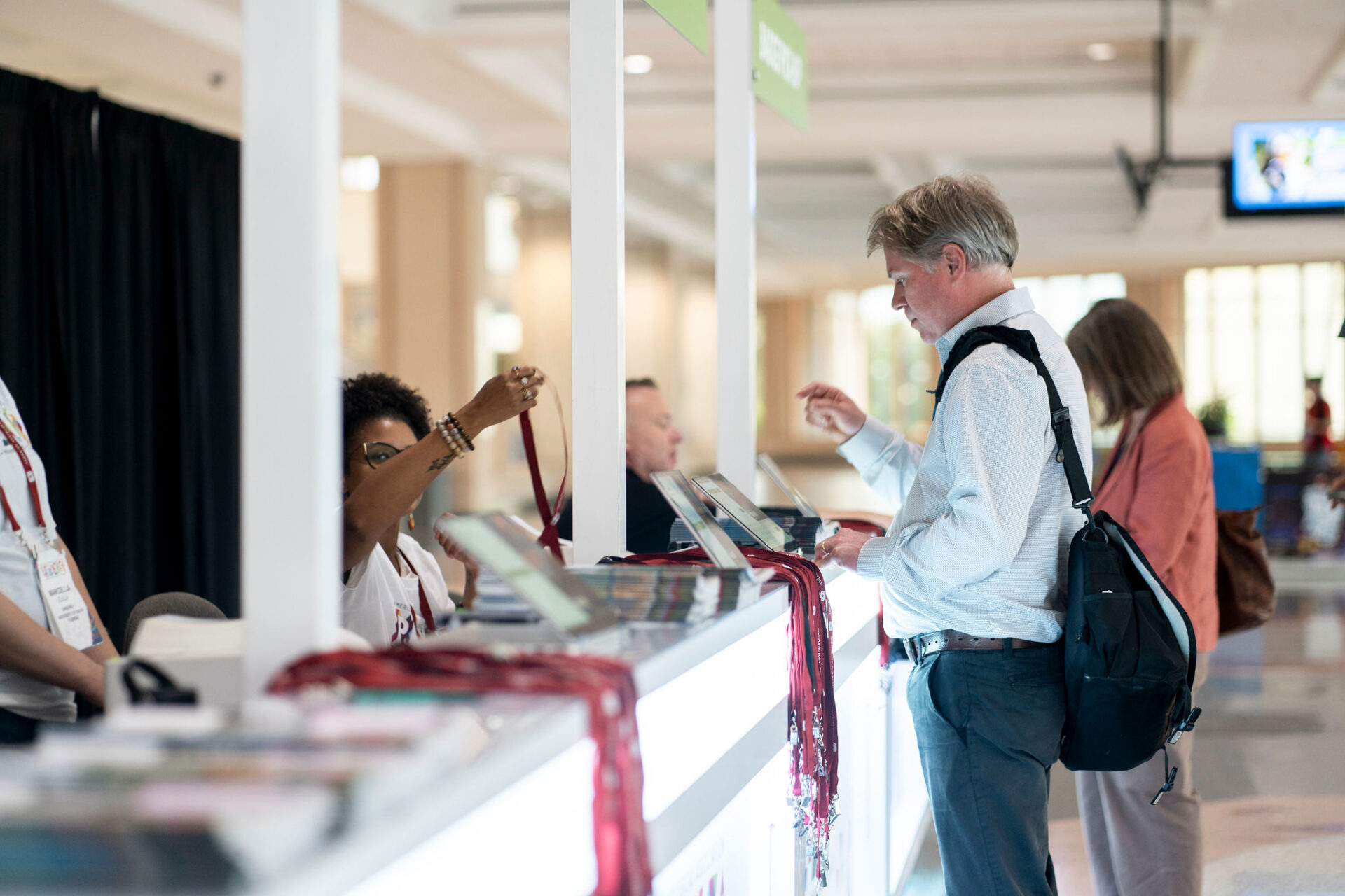 attendees registering for 2024 AAA Annual Meeting at registration booth