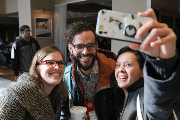 Three people take a selfie at the annual meeting