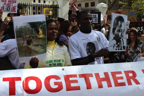 people hold signs during a gathering