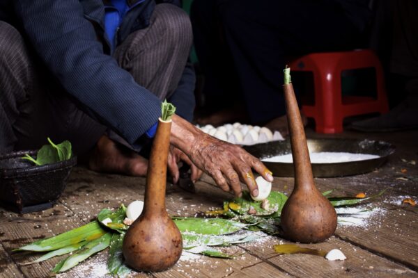 A persons had can be seen cracking an egg with various materials surrounding it