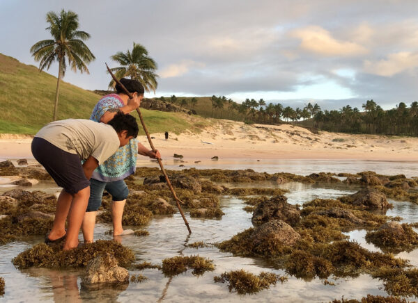 An image of two people during a sunset crabbing lesson