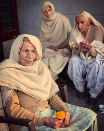 Three women sit together in India.