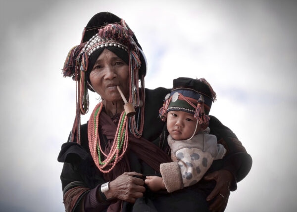 A portrait of a grandmother holding her grandson in South-West China.