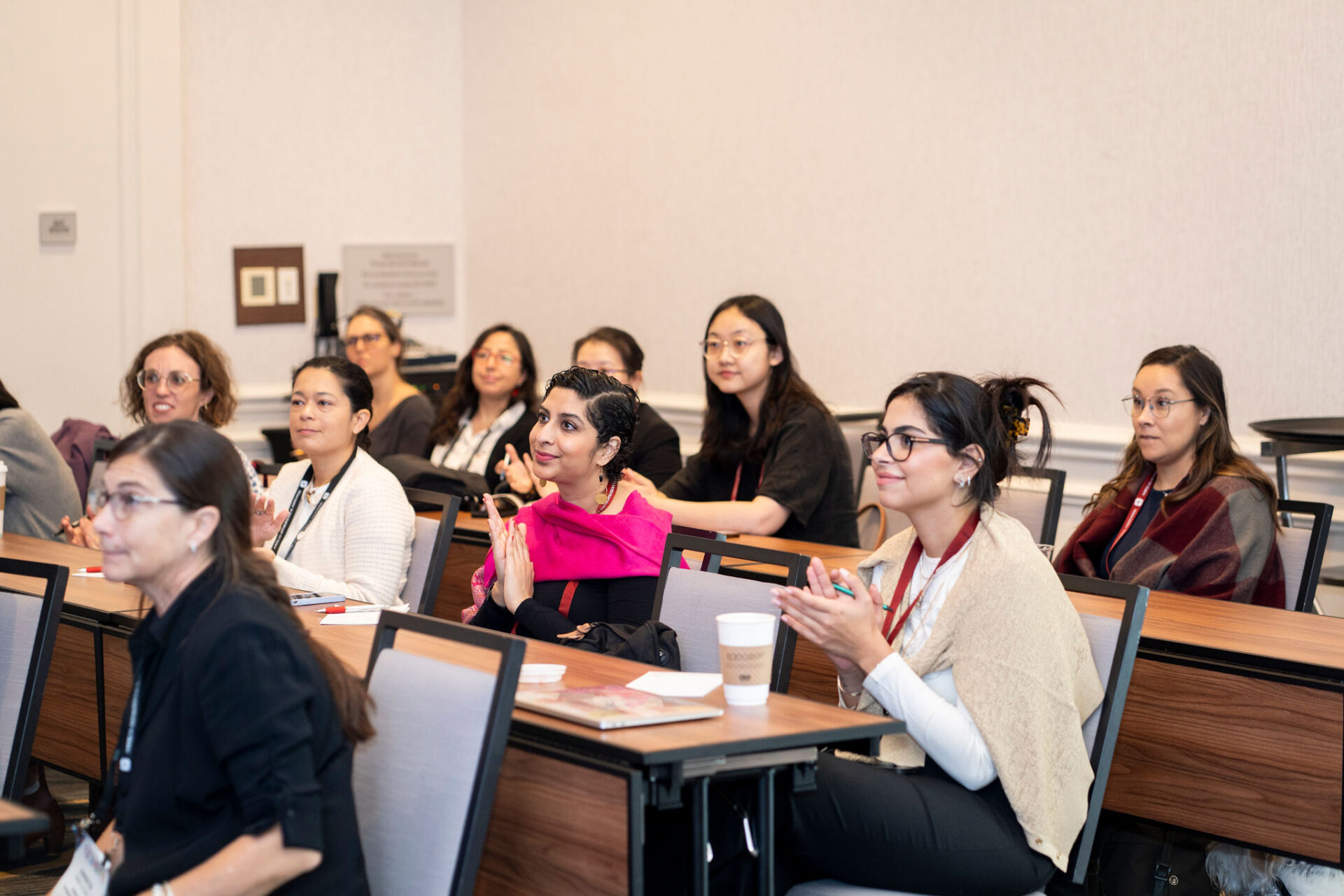 workshop attendees sitting at desks, paying attention to speaker