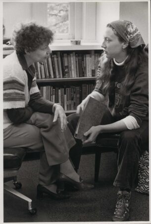 Ina Rosenthal-Urey (left) having a conversation with a student in a library