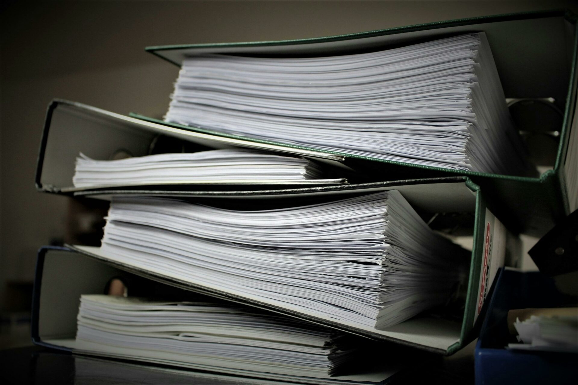 stack of binders filled with paper